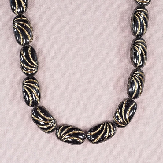 Steel gray with gold rectangular oval beads