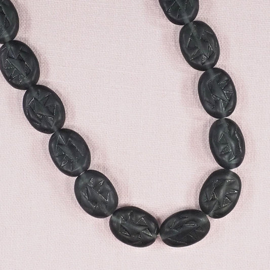 Frosted black incised lozenges