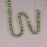 6 mm round green-clear beads