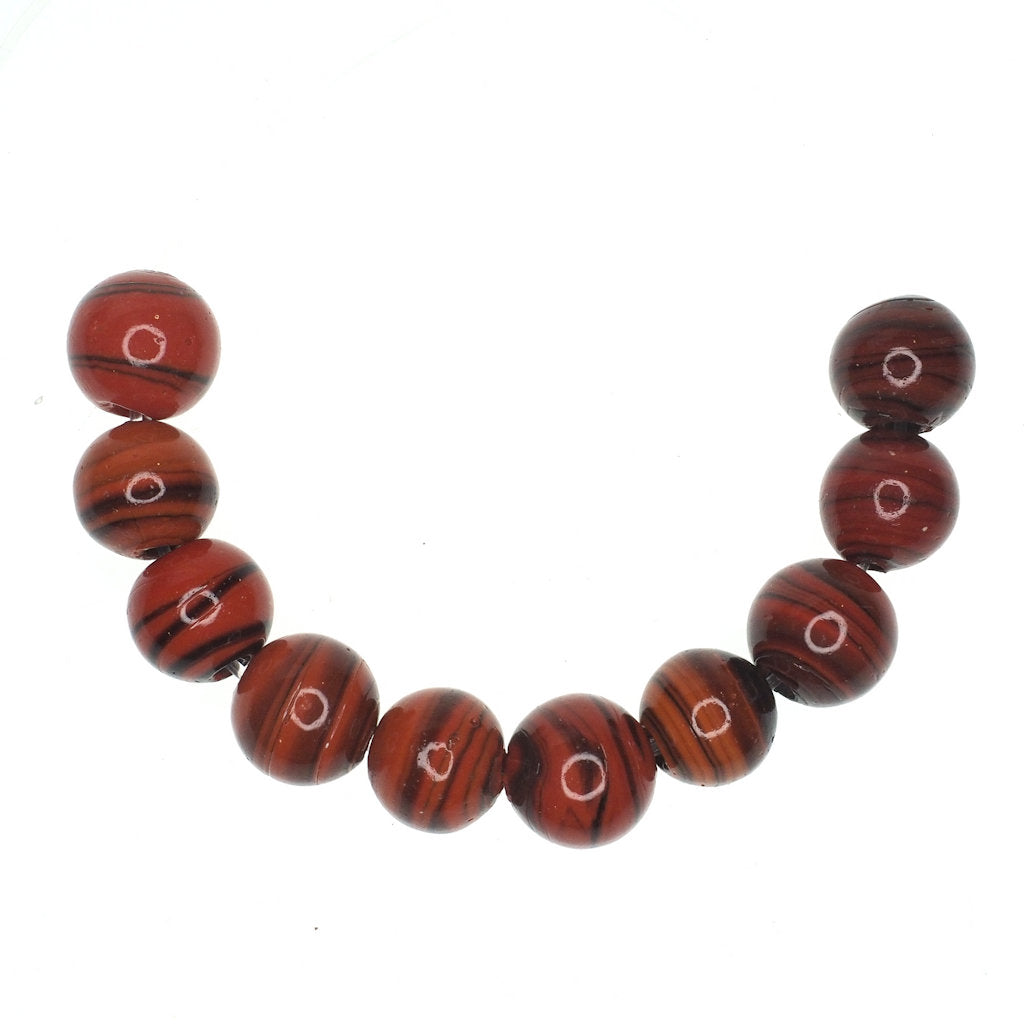 Dark orange striped round glass bead